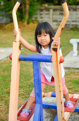 Obraz premium Cute litter girl exercise at playground