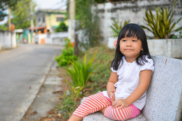 Naklejka premium Cute Asian girl waiting her mother
