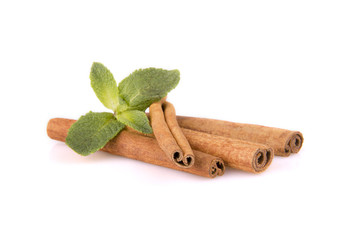 cinnamon sticks and mint leaf on a white background