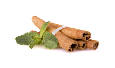 cinnamon sticks and mint leaf on a white background