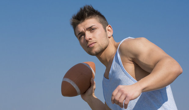 Muscular American Football Player Ready To Throw Ball