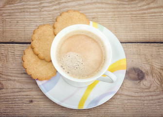 ginger cookies and a cup of coffee on old wood background