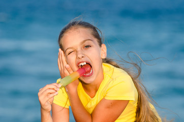 girl eating colorful tasty ice cream