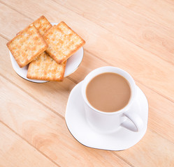 Coffee cup on the table with bread sticks.