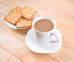 Coffee cup on the table with bread sticks.