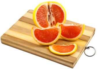 Obraz na płótnie Canvas Red grapefruit slices on a wooden board