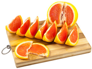 Obraz na płótnie Canvas Red grapefruit slices on a wooden board