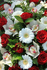 Cymbidium orchids, red roses and white gerberas