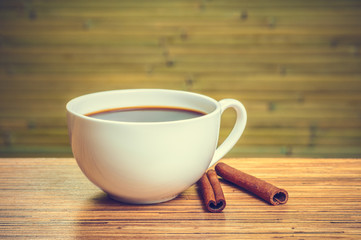 White cup of coffee with cinnamon