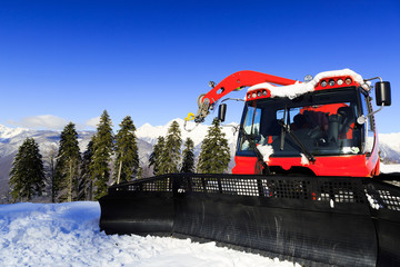 Snow-grooming machine on snow hill ready for skiing slope prepar - 63457153