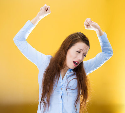 Sleepy yawning woman isolated on yellow background 