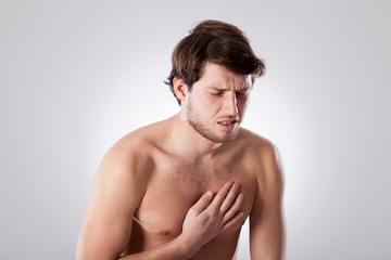 Fototapeta premium Naked man suffering from chest pain