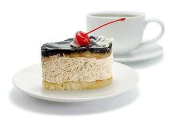 Chocolate cake with cherries and a cup of tea