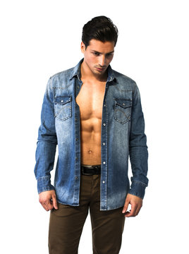 Latin young man with open denim shirt on naked chest.