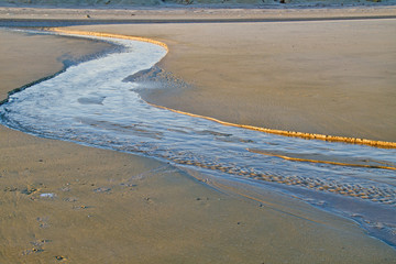 Creek on a beach at ebb tide