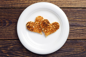 Two toast bread in the shape of hearts
