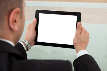Businessman Using Digital Tablet In Office