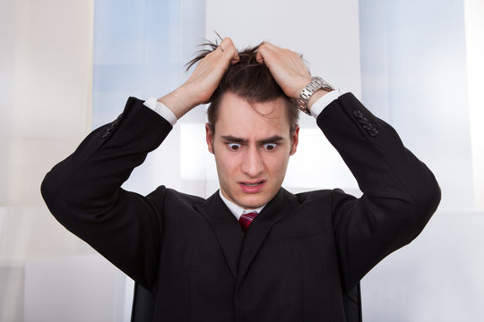 Confused Businessman Pulling Hair