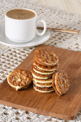 Fototapeta na wymiar Caramel Florentines cookies on a wooden cutting board