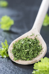Dried Parsley on a wooden spoon