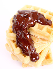 Waffles covered with chocolate on a white background