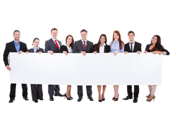 Large group of businesspeople presenting banner