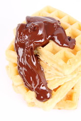 Waffles covered with chocolate on a white background