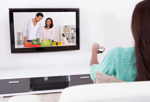 Woman Watching TV In Living Room