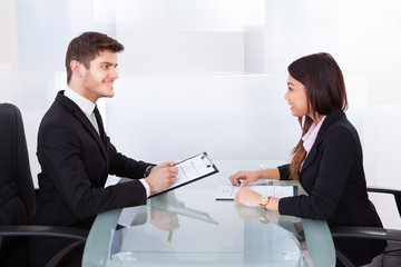 Business Colleagues Discussing At Desk