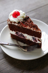 Dark chocolate cake on wood background