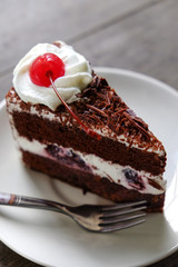 Dark chocolate cake on wood background