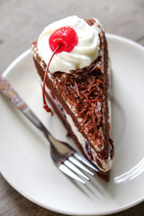 Dark chocolate cake on wood background