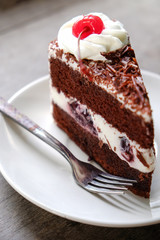 Dark chocolate cake on wood background