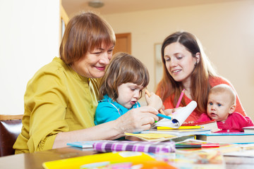 Fototapeta premium grandmother with daughter and grandchildren sketching at home