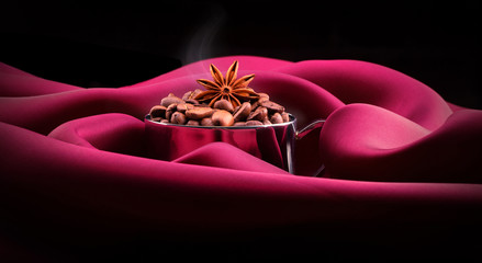 cup of Coffee with beans on red silk