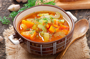 Vegetable soup on the old wooden background