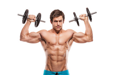 Muscular bodybuilder guy doing exercises with dumbbells over whi - 63477327