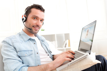 Young relaxed man video-calling on Internet