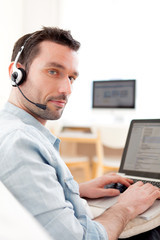 Young relaxed man video-calling on Internet