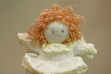 Knitted doll in a white dress