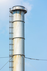 Factory Chimney Of Coal Power Plant Against Blue Sky