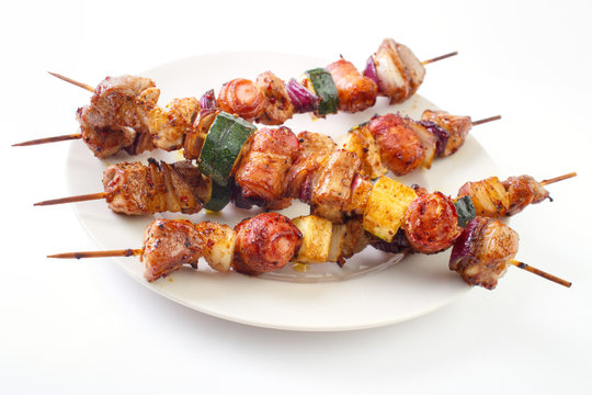 Grilled skewers with meat and vegetables on dish