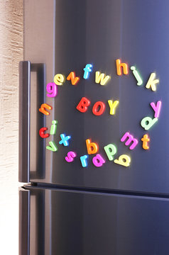 Word Boy spelled out using colorful magnetic letters