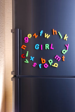 Word Girl spelled out using colorful magnetic letters