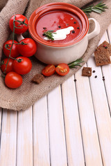 Tasty tomato soup on wooden table