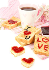 Delicious toast with jam and cup of tea on table close-up