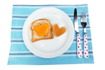 Scrambled eggs with bread on plate, on color napkin