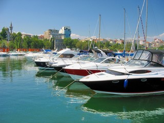 Fototapeta na wymiar Sailboat and Yacht anchored in the small port Tomis