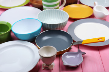 Different tableware on wooden background