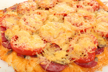 Homemade pizza on baking paper close up